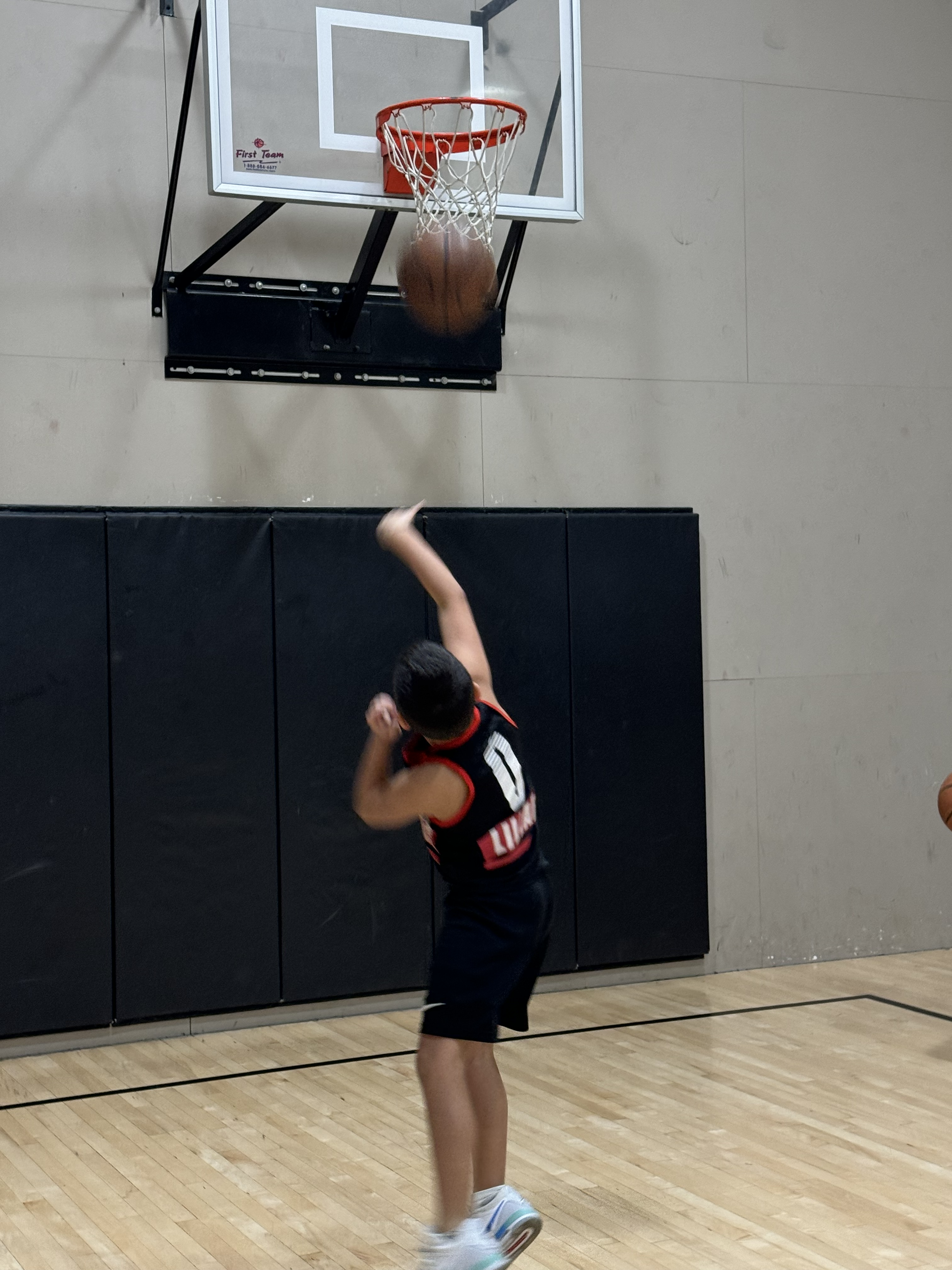 Youth player practicing layup during group training